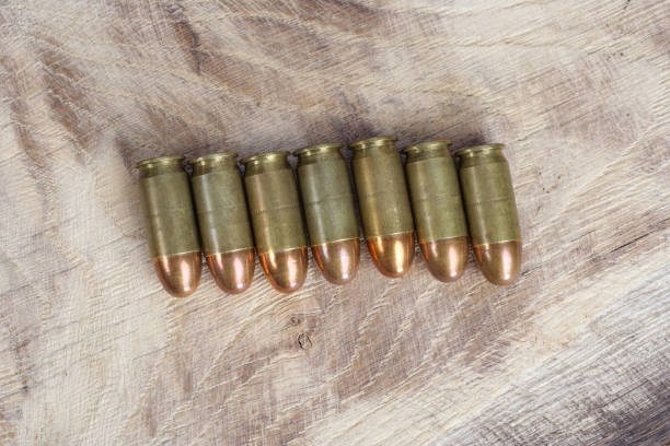 istock The .45 caliber cartridge on wooden background 1020774982