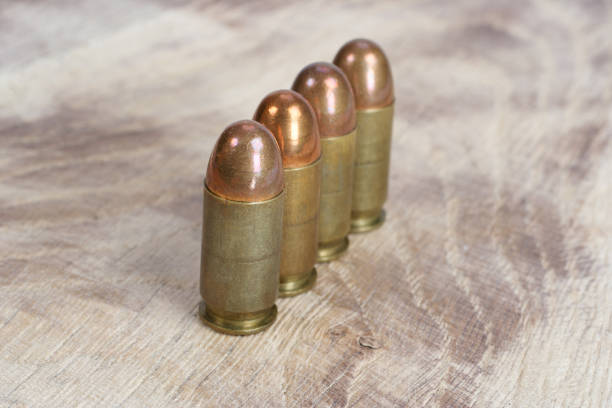 istock The .45 caliber cartridge on wooden background 1020775008