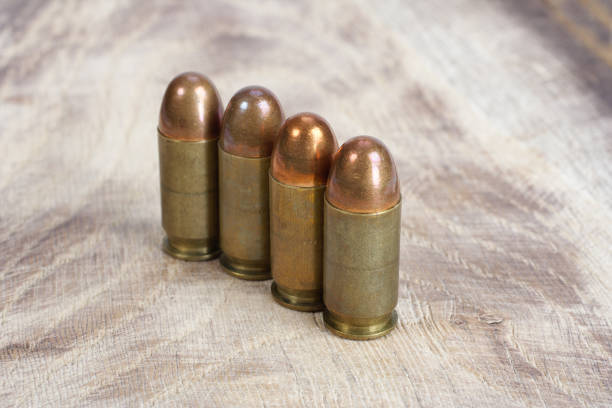 istock The .45 caliber cartridge on wooden background 1020775012