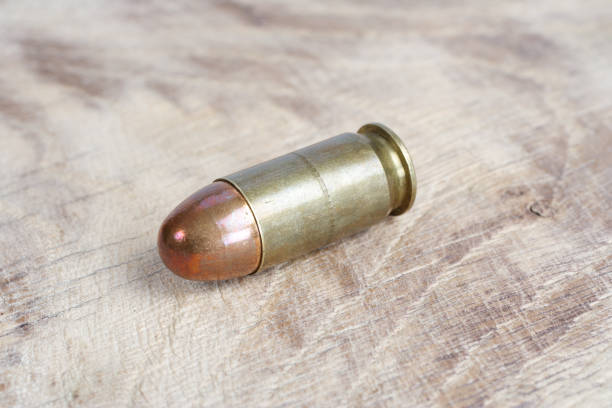 istock The .45 caliber cartridge on wooden background 1020775032