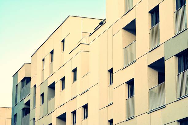 istock Modern apartment building exterior. Retro colors stylization 1020780190