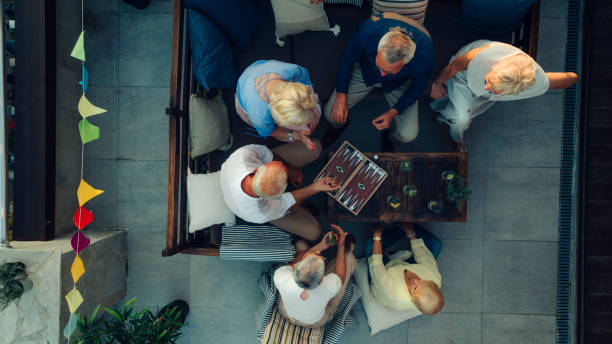 senior friends playing backgammon - backgammon imagens e fotografias de stock