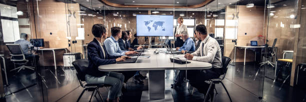 Corporate managers listening to a presentation in a conference room