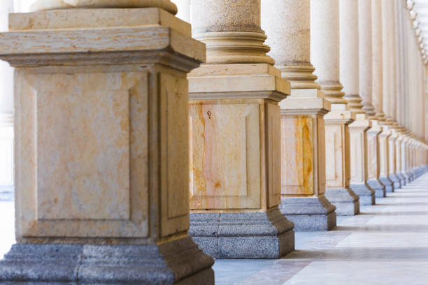 istock Colonnade, row of classical stone columns, background with copy spaced 1020794006