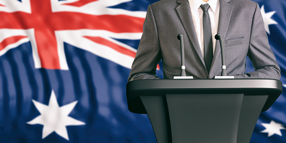 Businessman or politician making speech on Australia flag background. 3d illustration
