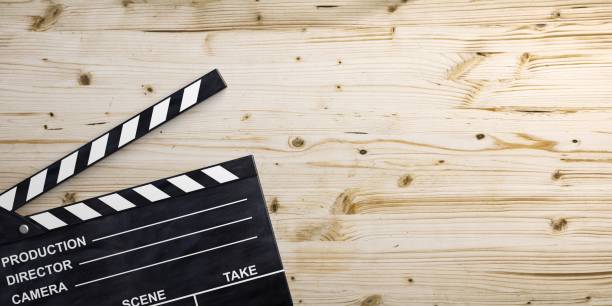 istock Movie clapper on wooden surface. 3d illustration 1020803516