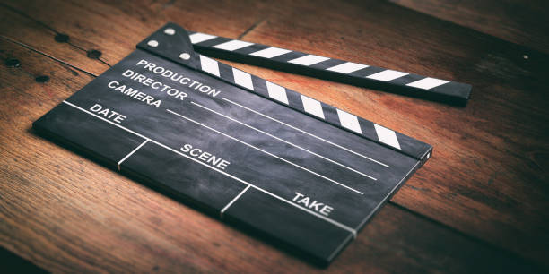 istock Movie clapper on wooden surface. 3d illustration 1020803530