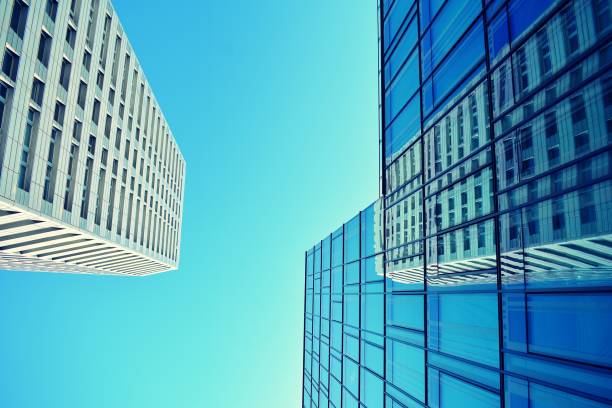 istock Modern office building on a clear sky background. Retro stylized colorful tonal filter effect 1020811036