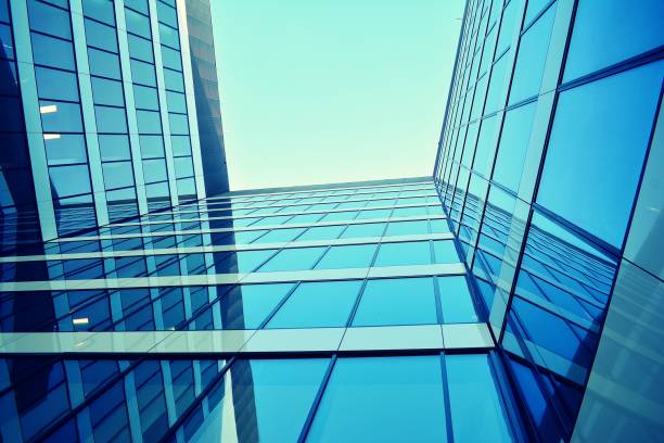 istock Modern office building on a clear sky background. Retro stylized colorful tonal filter effect 1020811764