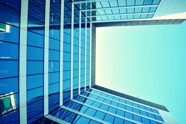istock Modern office building on a clear sky background. Retro stylized colorful tonal filter effect 1020814068