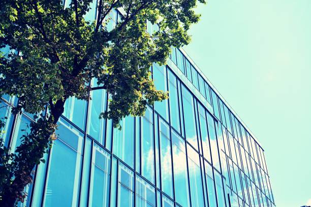 istock Modern office building on a clear sky background. Retro stylized colorful tonal filter effect 1020814420