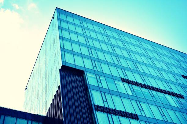 istock Modern office building on a clear sky background. Retro stylized colorful tonal filter effect 1020818576