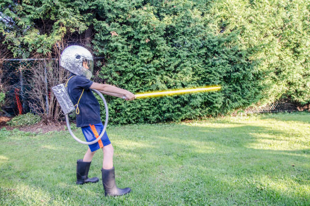 istock Young boy dressed as an astronaut in the backyard during summer day 1020819078