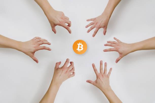 istock Top view of hands reaching for bitcoin. 1020821358