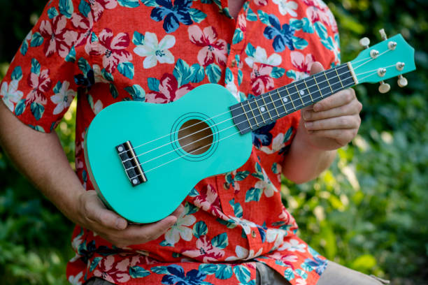 istock man with hawaiian shirt and ukulele 1020837150