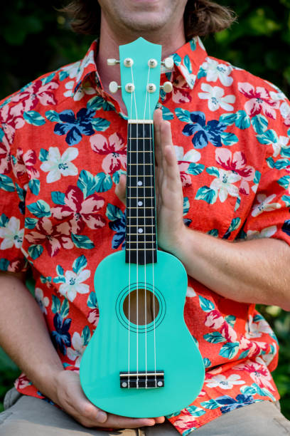 istock man with hawaiian shirt and ukulele 1020837152