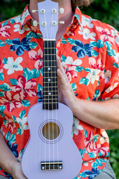 istock man with hawaiian shirt and ukulele 1020837158