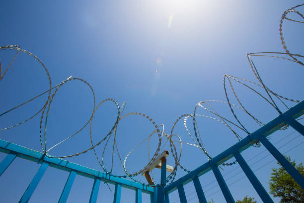 istock Blue Fence made of wire with spikes on top 1020844294