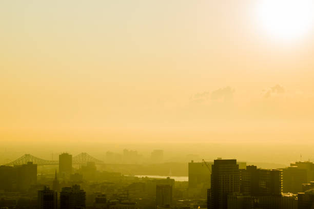 Sunrise over Montreal with some clouds on a hot summer day. View from Mount Royal Park.