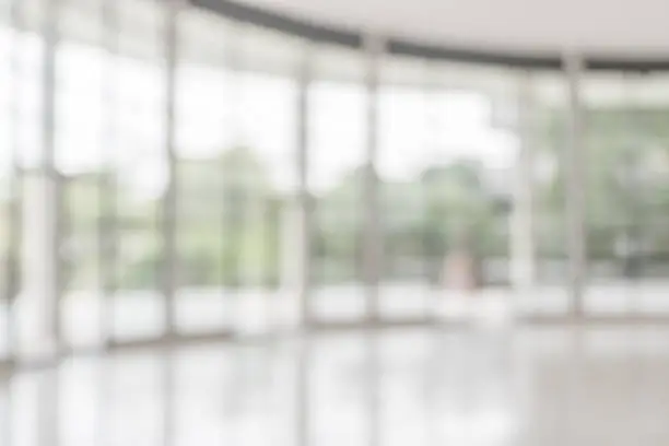 Photo of Blur abstract background interior view empty office lobby with entrance doors and glass curtain wall