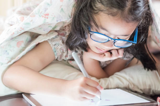 istock Asian school child girl using smart tablet device digital technology drawing on innovative touchscreen surface 1020849512