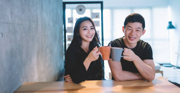 istock asian chinese couple at the dining chatting bonding time while having their coffee in the morning looking at camera smiling 1020897742