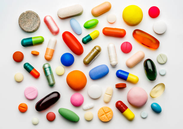 istock Large group of assorted capsules and pills on white background 1020915938
