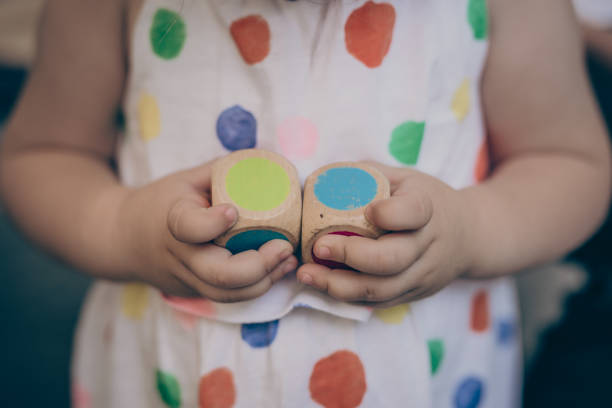 istock Wooden dice in child hands 1020949970