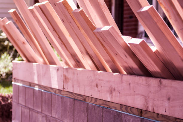 istock Wooden Lumber Planks Leaning Against New Foundation Wall 1020972768