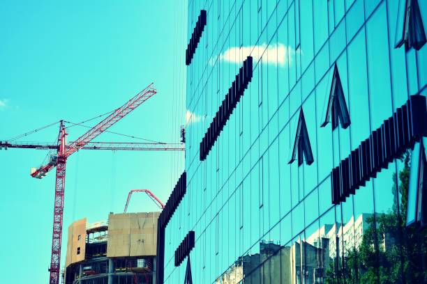 istock Modern office building on a clear sky background. Retro stylized colorful tonal filter effect 1020973014