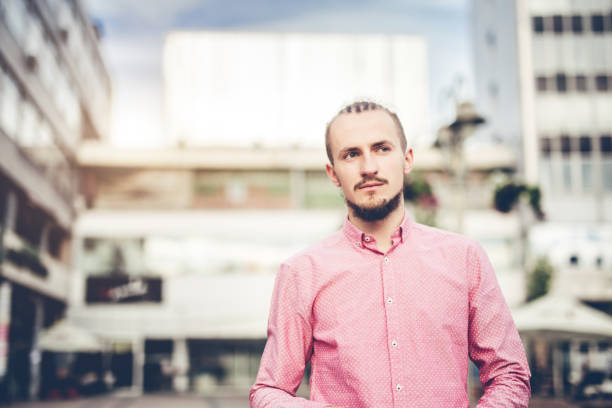 istock Young stylish man walking through the city square. 1020975792