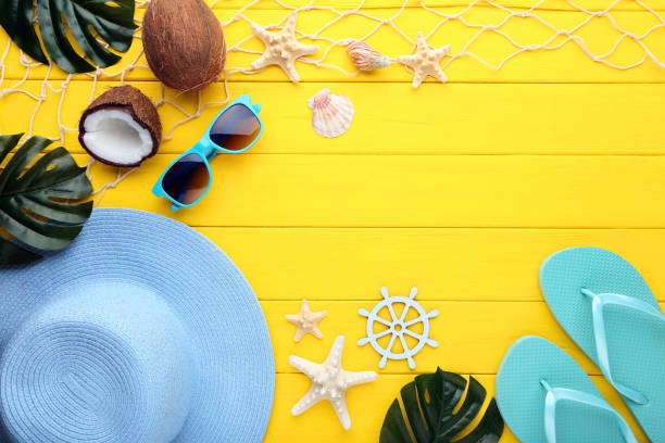 istock Beach accessories with seashells and monstera leafs on wooden table 1020985366