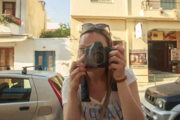 Photo of Pretty woman taking a photograph of herself in a mirror of showcase.