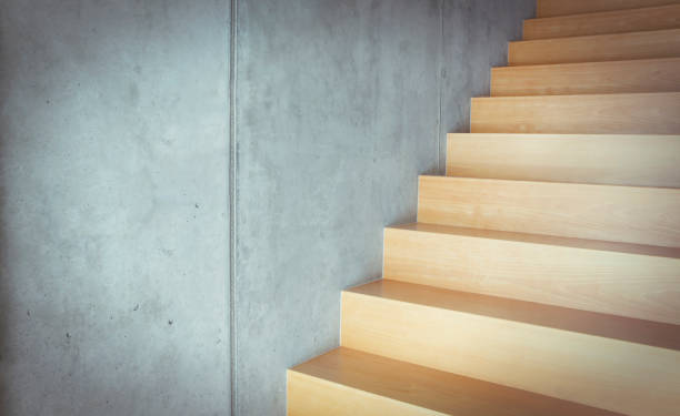 istock Wooden stairs at concrete wall 1021000528