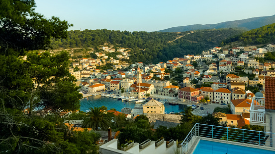 A view of the small coastal Croatian town of Pucisca on the island of Brac, Dalmatia, Croatia.
Sunny summer afternoon - golden hour. Holidays travel destination.