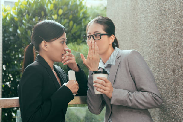 asiatische frauen reden büroklatsch - whispering women talking mystery stock-fotos und bilder