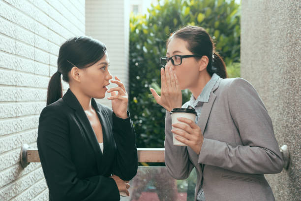 istock women talking about office gossip 1021017408