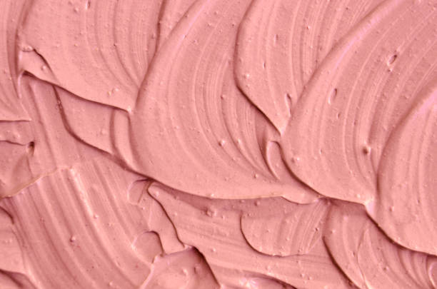 istock Soft pink cosmetic clay (facial mask, cream) texture close up, selective focus. Abstract background with brush strokes. 1021041098