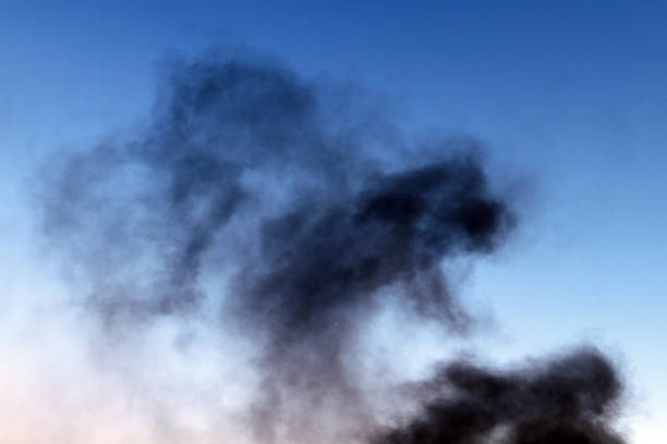 istock dark smoke on the light sky background. 1021041364