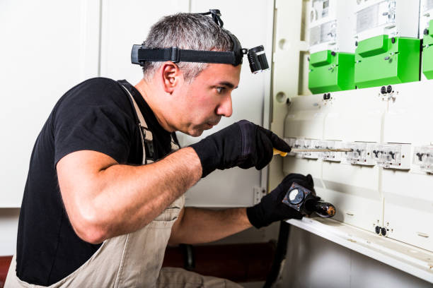 istock Electrician repairs and measures fuse box or switch box 1021053512