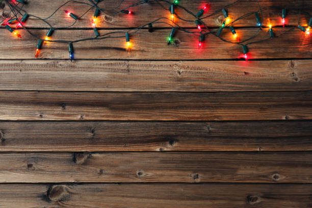 istock Christmas garland lights on brown wooden table 1021054590