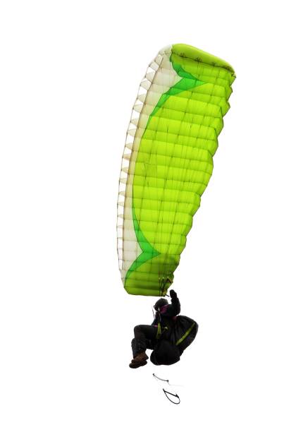 paraglider flying high with his green paragliding - airplane sky extreme sports men imagens e fotografias de stock