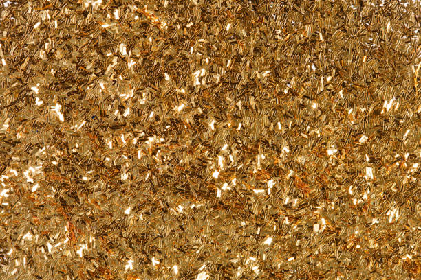 Golden glitter texture, abstract background on macro