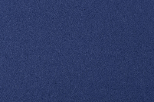 Dark blue colored felt texture background on macro