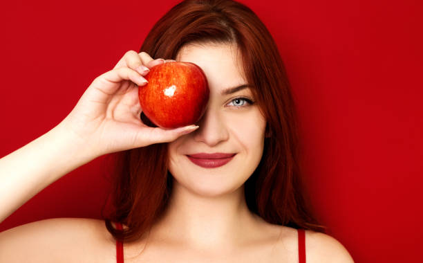 istock Woman holding apple 1021086884