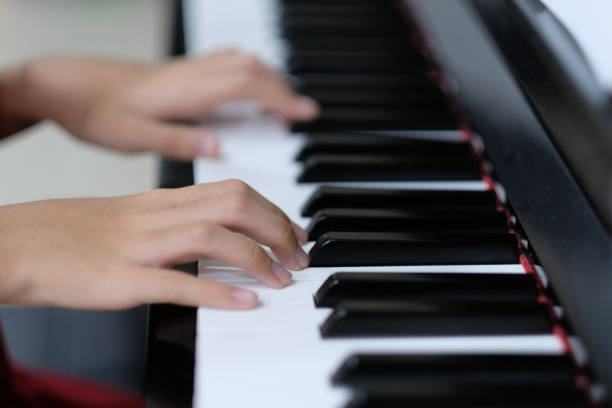 istock Child hand on piano keys 1021089428