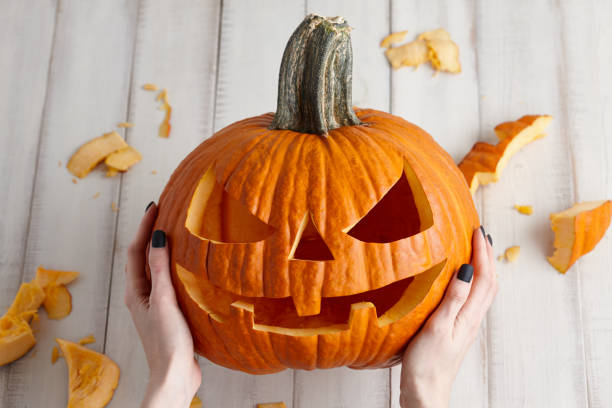 Carving halloween pumpkin into jack-o-lantern, close up view