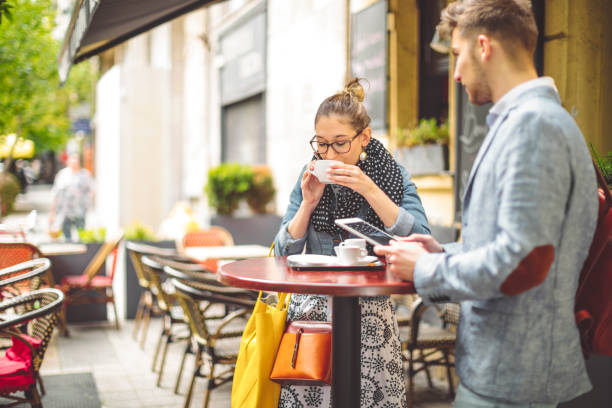 istock Friends are having a hot drink in a sidewalk cafe 1021096836