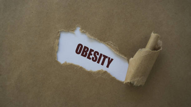 istock obesity written on torn paper 1021097186