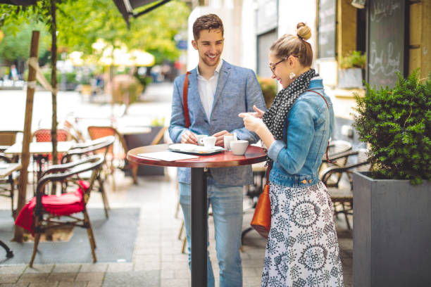 istock Friends are having a hot drink in a sidewalk cafe 1021101282